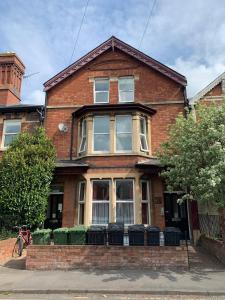 a red brick house with a large window at Hereford City - Victory Apartment - Modern Studio In Vibrant Popular Area of Hereford - Hosted by RENTMYHOUSE in Hereford