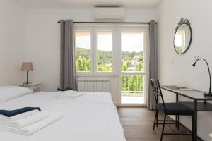 Postel nebo postele na pokoji v ubytování Apartments Ivan Zaton