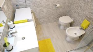 a bathroom with a white toilet and a sink at Apartment Mistral in Badesi