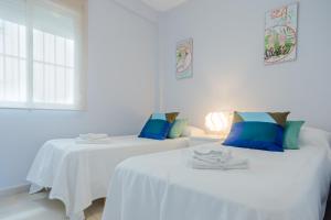 Ένα ή περισσότερα κρεβάτια σε δωμάτιο στο Apartamento Sea Views Rota
