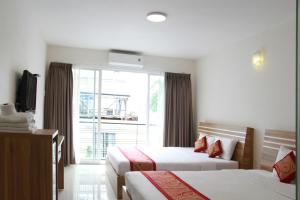 a hotel room with two beds and a window at Ngoc Minh Hotel in Ho Chi Minh City