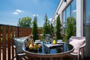 a patio with a table and chairs on a balcony at Hotel Zoo by Afrykarium Wroclaw in Wrocław