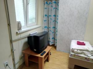 a small room with a television and a bed at Hotel Uyut in Bilhorod-Dnistrovskyi