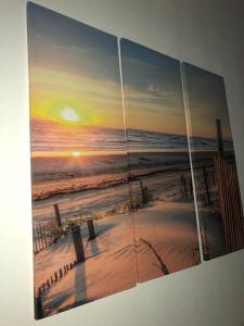 a painting of a beach with the sunset at Apartment Antonija in Povile