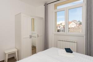 Postel nebo postele na pokoji v ubytování Apartments Ivan Zaton