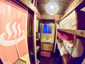 a small bathroom with a sink and a toilet at Benidaruma - Sakuramochi in Kyoto