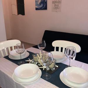 a table with white plates and wine glasses on it at Apartment Antonija in Povile