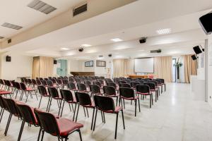 a large room with chairs and a screen at Kursaal Hotel in Cattolica