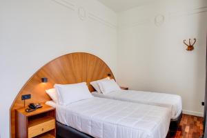 Кровать или кровати в номере Kursaal Hotel