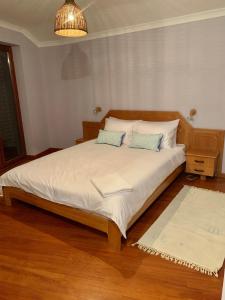 a bedroom with a large bed with two pillows at The Old Man and the Sea in Nesebar