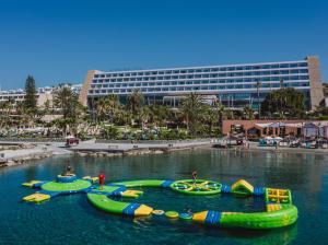 a group of inflatable boats in a body of water at Amathus Beach Hotel Limassol in Limassol