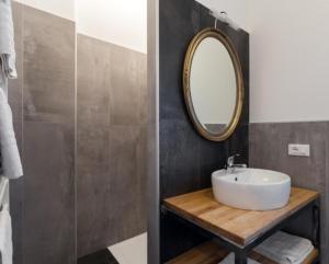 a bathroom with a sink and a mirror at Appartamento Vo' 74 in Trento