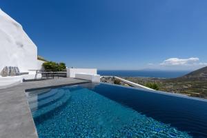 a swimming pool in a villa with blue water at Delilah Villa by Senses Collection in Pyrgos