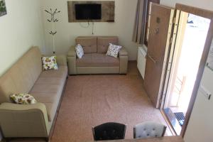 a living room with a couch and a chair at Uzungol Selale otel Bungalow in Uzungöl