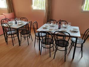 a dining room with a table and chairs with wine glasses at Residencial El Cuartel in Grañón
