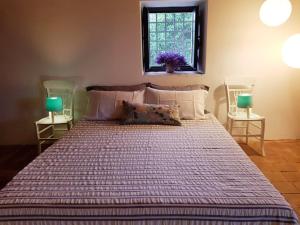 a bedroom with a large bed with two night stands at L'Aranceto in Acireale