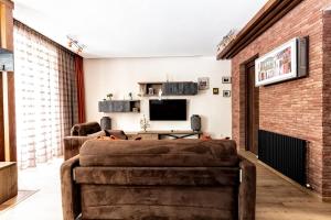 een woonkamer met 2 banken en een bakstenen muur bij Old Walls 1 in Tbilisi City +38 foto's