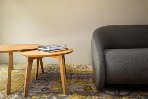 a table next to a chair and a table with books on it at ION Adventure Hotel, Nesjavellir, a Member of Design Hotels in Nesjavellir