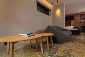 a living room with a couch and a table at ION Adventure Hotel, Nesjavellir, a Member of Design Hotels in Nesjavellir