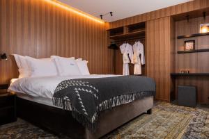 a bedroom with a large bed and a closet at ION Adventure Hotel, Nesjavellir, a Member of Design Hotels in Nesjavellir