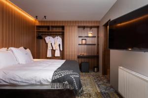 a hotel room with a bed and a flat screen tv at ION Adventure Hotel, Nesjavellir, a Member of Design Hotels in Nesjavellir