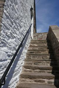 a stairway leading up to a brick wall at Captains Lookout (Studio apartment) in Brecon