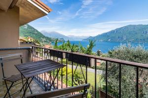 a balcony with a bench and a view of a lake at Villa Panorama in Oliveto Lario