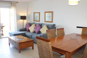 a living room with a couch and a table at Agi Torre Quimeta Apartments in Roses