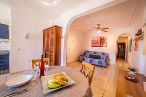 a dining room and living room with a table at Plaza Vista Mar Dos in Los Abrigos