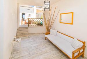 a living room with a couch and a mirror at Villa LA CALMA Alcudia in Alcudia