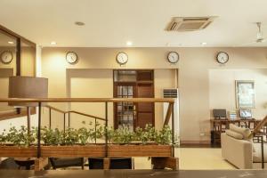 a living room with clocks on the wall at Casa Bocobo Hotel in Manila