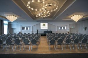 a room with rows of chairs and a screen at Longcourt House Hotel in Newcastle West