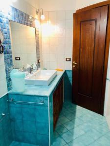 a bathroom with a sink and a mirror at Villa Edo in Cala Liberotto