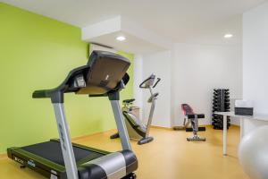 a gym with a treadmill and two exercise bikes at Hotel Florida in Lisbon