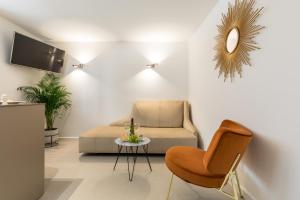 a living room with a couch and a chair and a table at Park Residence in Split