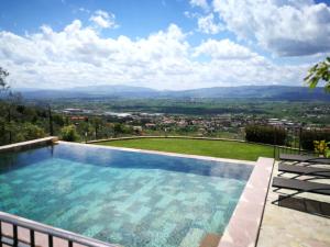 a swimming pool with a view of a city at Domus Clara in Assisi