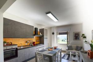 cocina y sala de estar con mesa y sillas en Monteleto House.. dove Pace regna, en Gubbio
