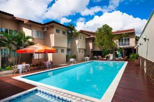 a swimming pool in front of a house at Hotel 365 in Cuiabá