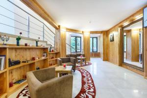 a large room with wooden walls and chairs and tables at Baron SPA Hotel - Museum Yaremche in Yaremche