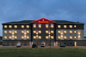 a large building with a redania sign on it at Ramada by Wyndham Drayton Valley in Drayton Valley