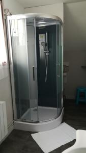 a shower with a glass door in a bathroom at La CHAMBRE in Évran