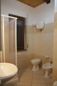 a bathroom with a shower and a toilet and a sink at Hotel Maremonti in Ioppolo