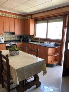 a kitchen with a table and a sink in it at Casa Rural "Casa Maria" in Artana