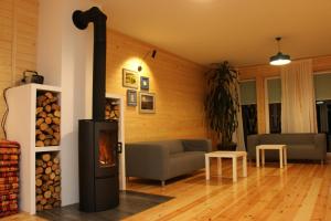 a living room with a wood burning stove at Gościniec Celina in Krasnobród