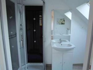 a white bathroom with a sink and a shower at Les Chambres de Pascaline in Arrest