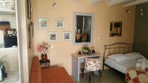 a bedroom with a bed and a table and a mirror at Ierapetra Garden House in Ierapetra
