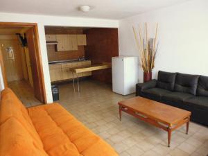a living room with a couch and a table at Hotel San Luis in San Luis Potosí