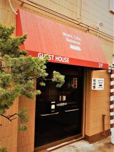 a store front of a gin st house with a red awning at Work Life Balance Busan Station in Busan
