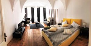 a bedroom with a bed and a living room at Arcade Apartment in Sibiu