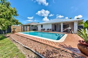 a swimming pool in the backyard of a house at Avanti Vacation Rental in Naples